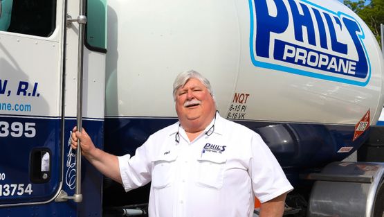 Phil's Propane employee standing near his delivery truck