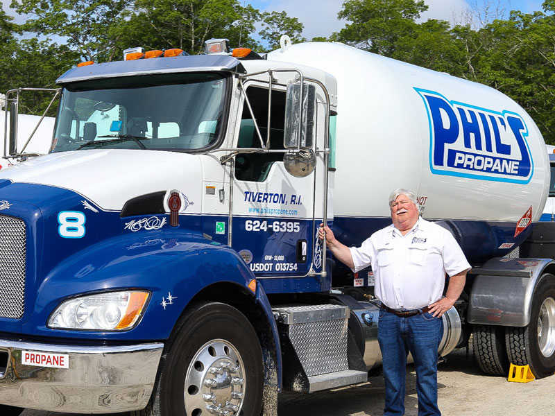 Phil's Propane employee standing near his delivery truck